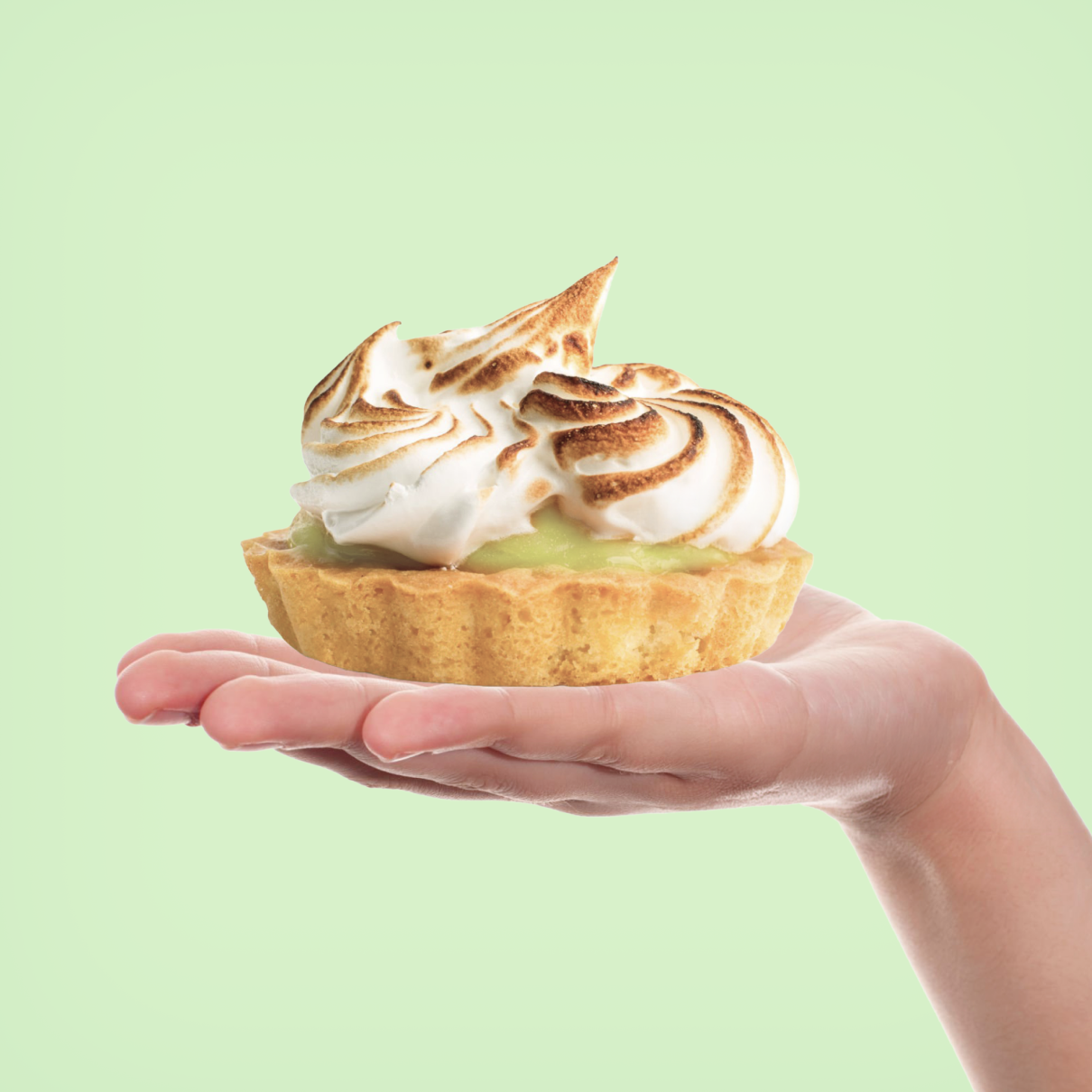 Hand holding a Key Lime Pie Tartlet